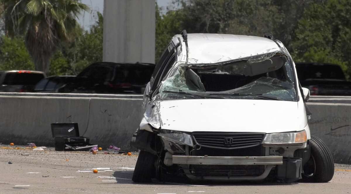 Houston police officers investigate a crash that sent two juveniles to Texas Children's Hospital along the Gulf Freeway on Monday, June 3, 2019.