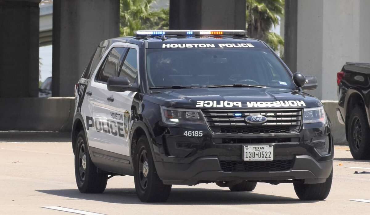 Houston police officers investigate a crash that sent two juveniles to Texas Children's Hospital along the Gulf Freeway on Monday, June 3, 2019.