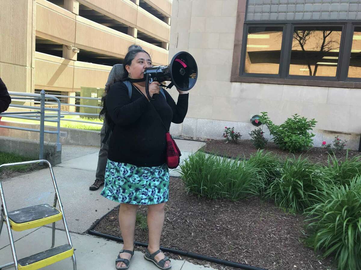 Parent Fatima Rojas leads a rally of more than 100 community members on June 3, 2019, in protest of 53 New Haven teacher job eliminations.