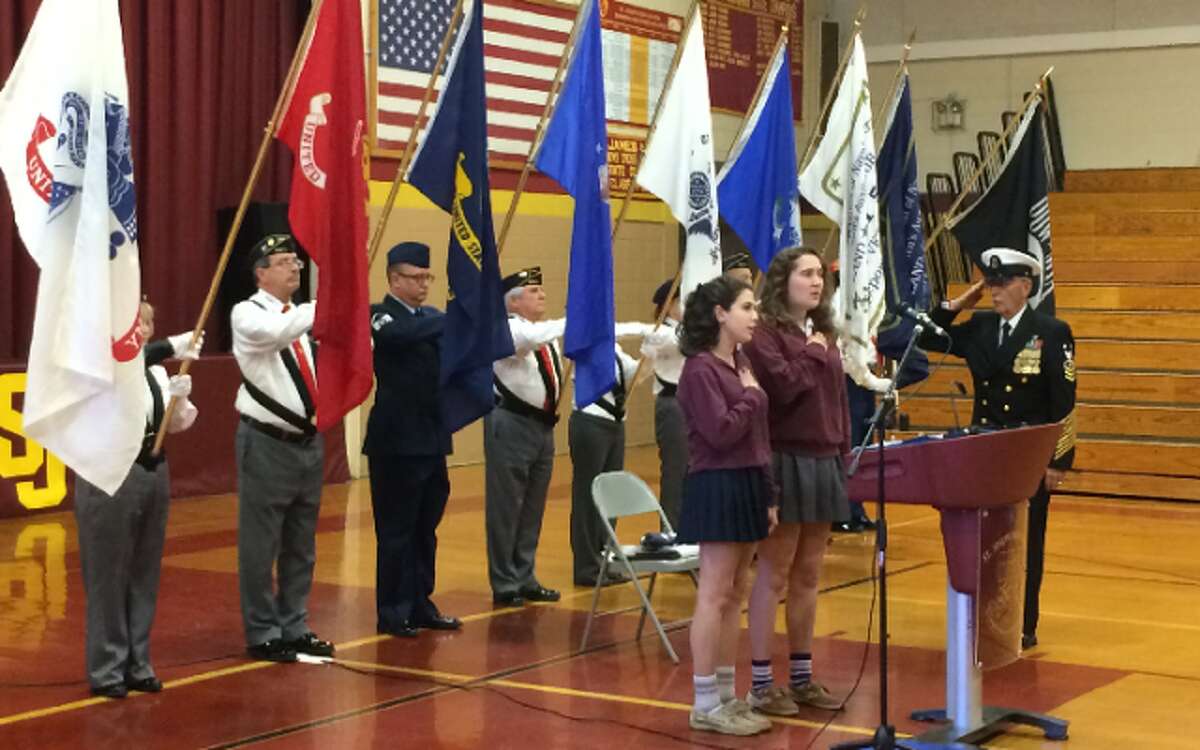 Master Chief Richard Iannucci salutes during the playing of the National Anthem before Friday’s Veterans Day assembly at St. Joseph High School. — Donald Eng