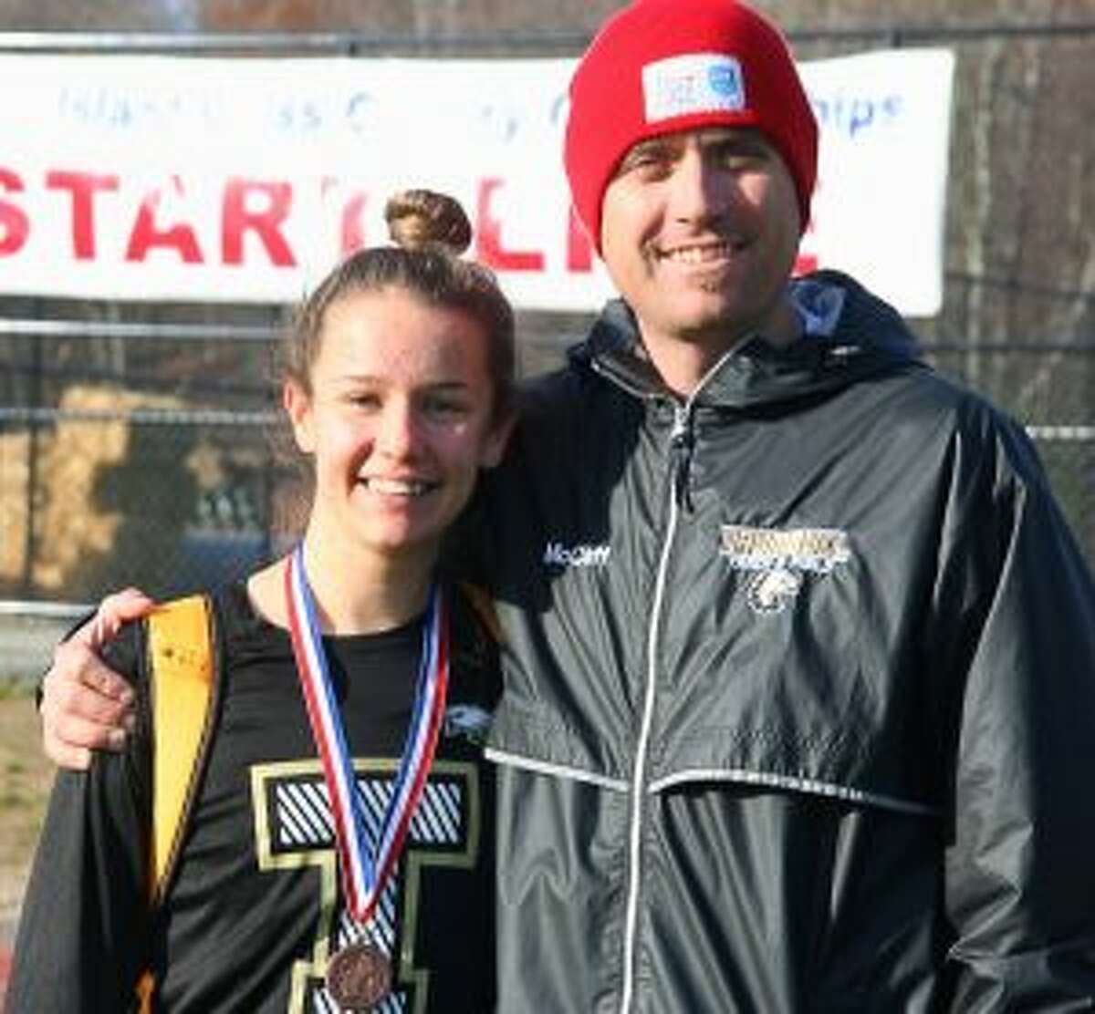 Trumbull High’s Kate Romanchick, pictured with Eagle coach Jim McCaffrey, placed 25th and medaled at the New England Cross Country Championships.
