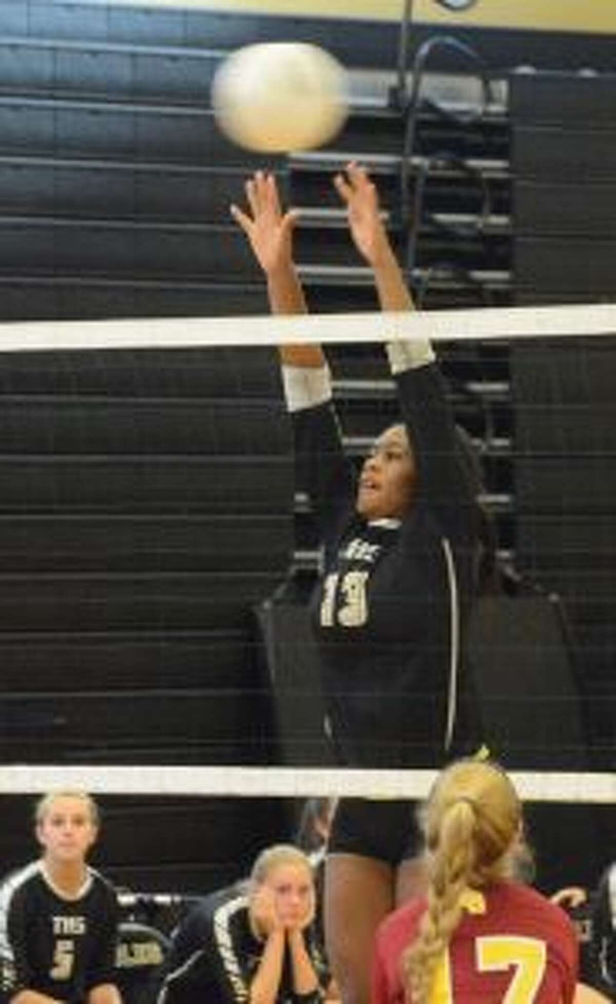 Trumbull High's Imani Bell goes up for a block. — Andy Hutchison photo