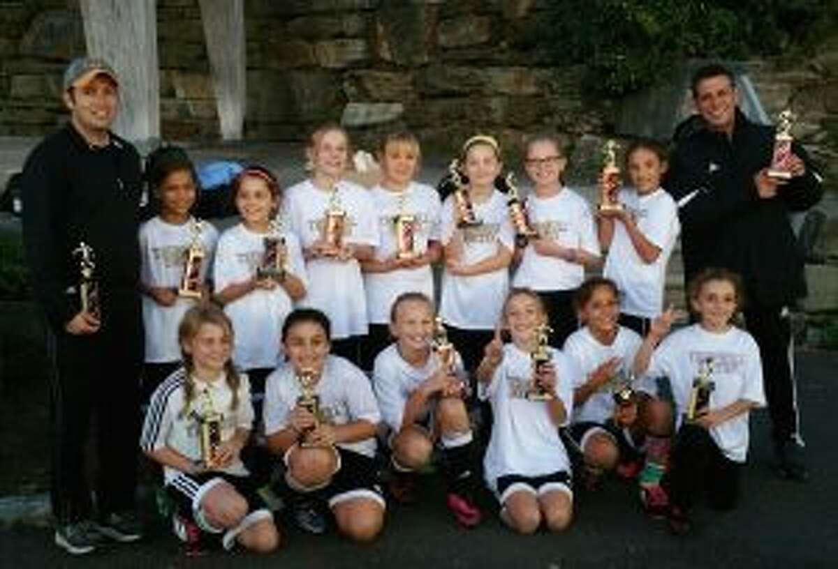The U-11 Trumbull Tornadoes celebrate their strong finish in the Rocky Hill Tournament. The team consists of coach Cipriano Pinto, Sophia Bennett, Briana Buda, Lucy Carlson, Adele Datz, Brooke Hebeler, Ellie Hebeler, Leela Kocinsky, Abby Lee, Mia Mallone, Katie Marchand, Anabela Martins, Jane Parente, Hope Platt and Avianna Rivera.