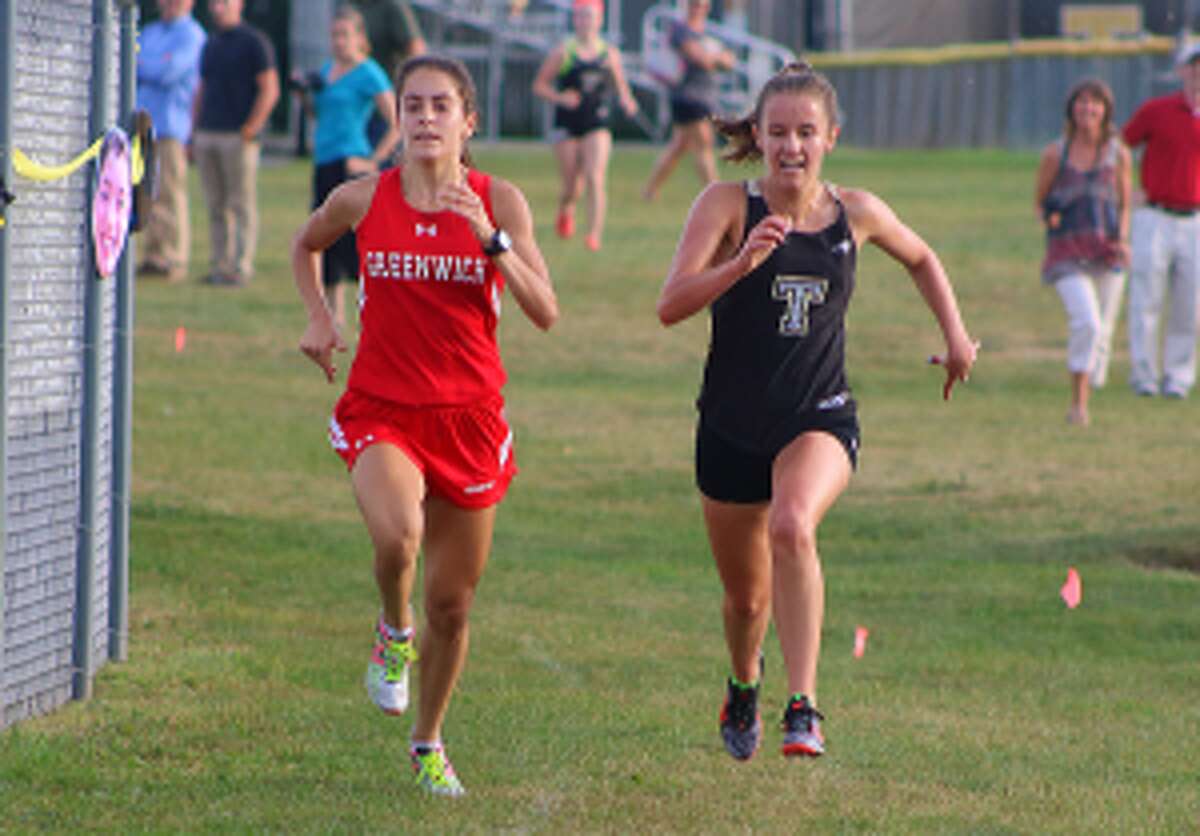Trumbull's Kate Romanchick and Greenwich's Emily Philippides race to the finish line.