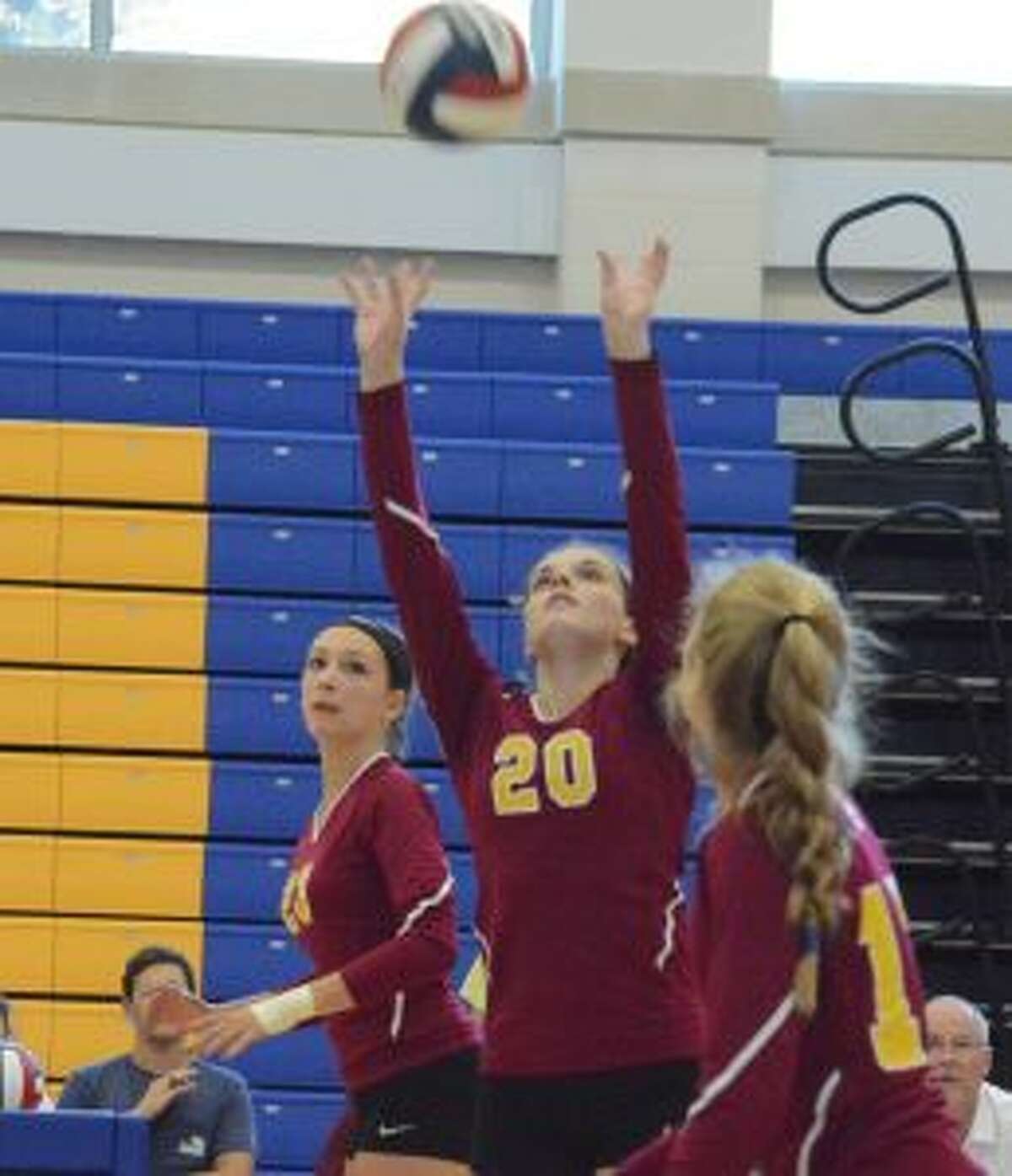 Megan Robinson sets the ball for St. Joseph in its 3-2 win over Newtown. — Andy Hutchison photo