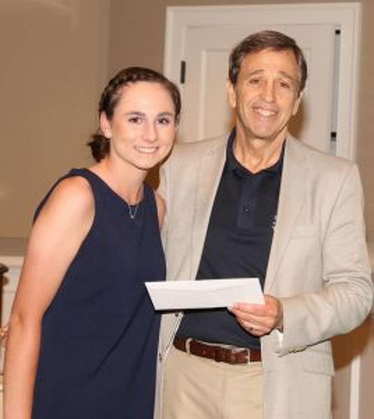 Alexa Brown, from Trumbull High School, receives a golf scholarship from Martin D. Schwartz, President and CEO of The Kennedy Center, during the Center’s Charity Golf Classic at Shorehaven Golf Club in Norwalk.