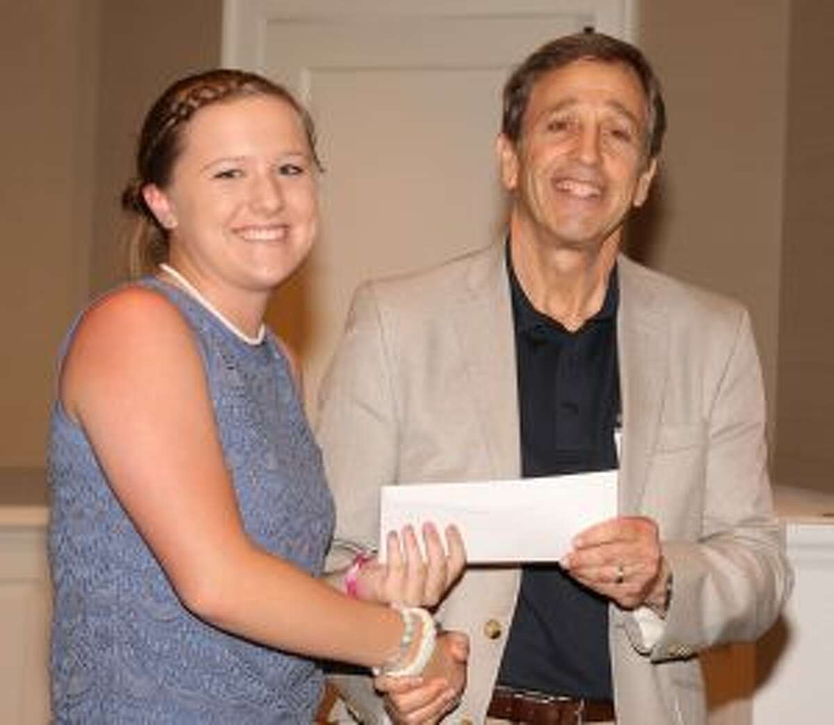 Martin D. Schwartz, President and CEO of The Kennedy Center, presents Grace McLean, a student at Trumbull High School, with a scholarship at Shorehaven Golf Club in Norwalk.