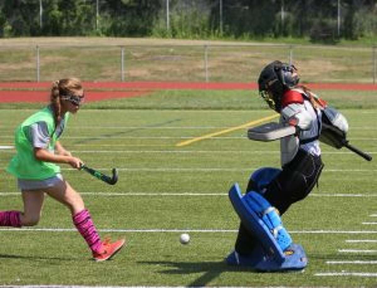 Bella Socci looks to put a goal past Emma Turiano during the Field Hockey Fun Camp at Trumbull High.
