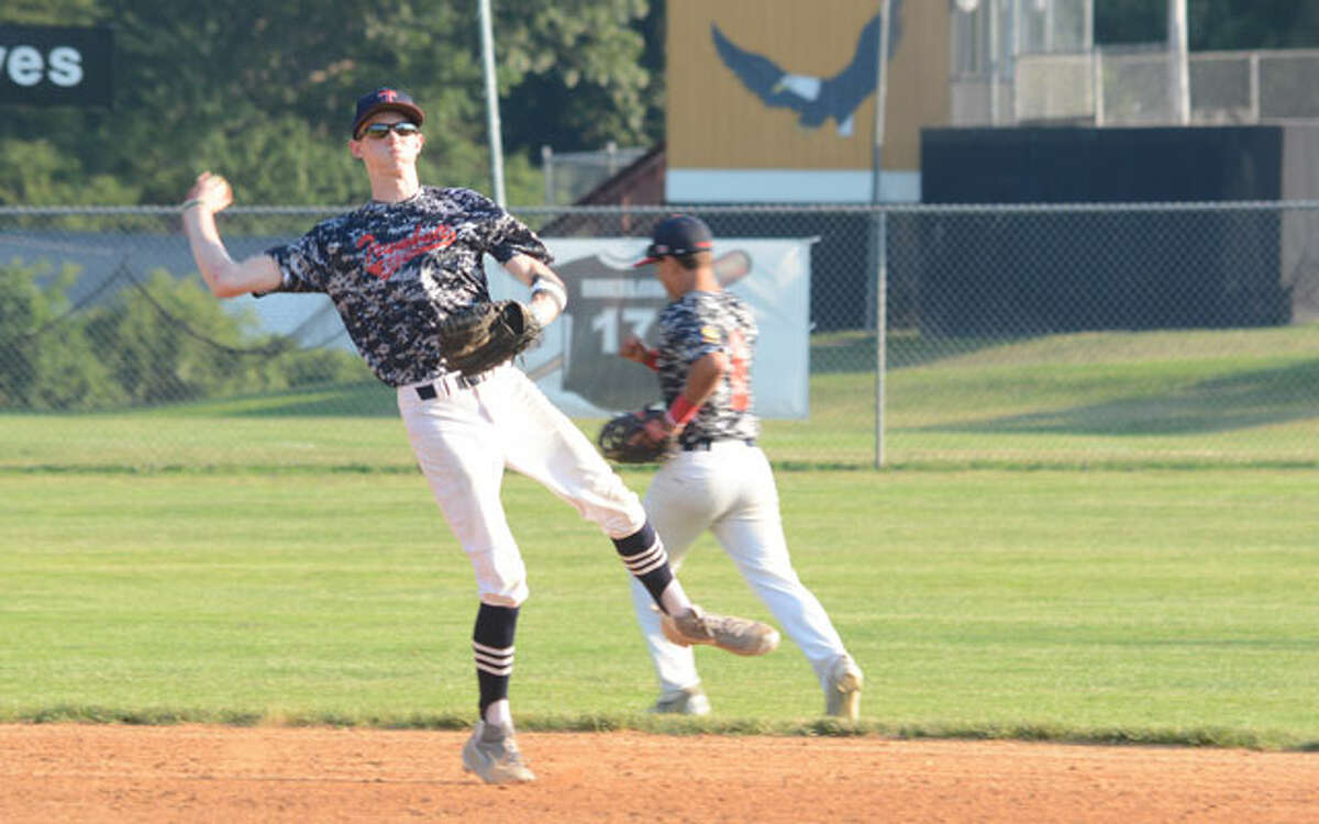 Trumbull shortstop Jack Lynch ranges to make a play against Darien/New Canaan. — Andy Hutchison photo