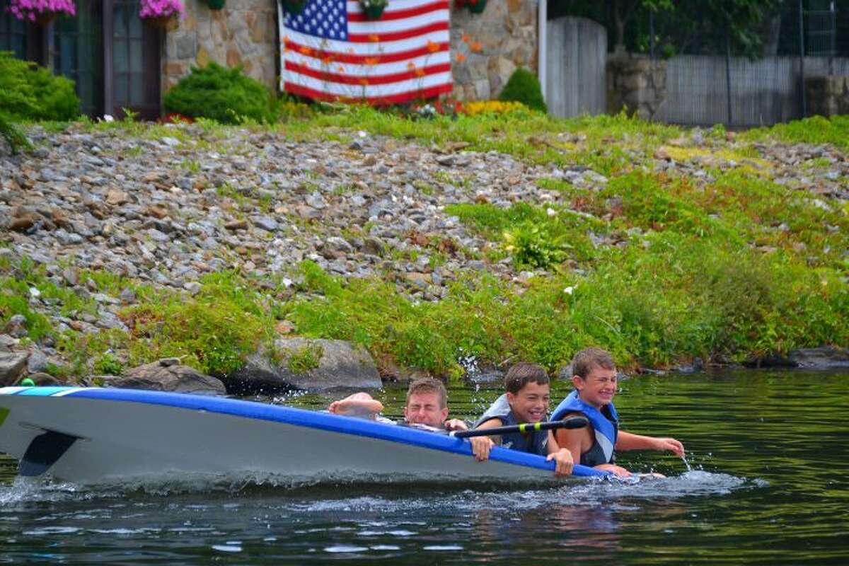 Trumbull residents Jason, Jack, and Billy go overboard into Pinewood Lake over the Fourth of July weekend. — Lisa Romanchick photo