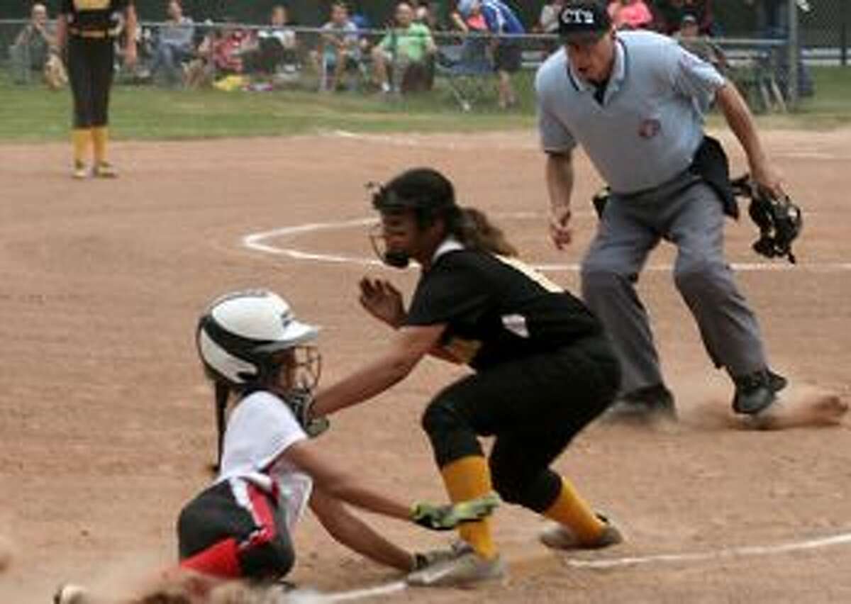 Trumbull third baseman Daniella Chanaca puts the tag down on Monroe’s Jacie Hall, as umpire V.J. Sarullo waits to make the out call. — Bill Bloxsom photo