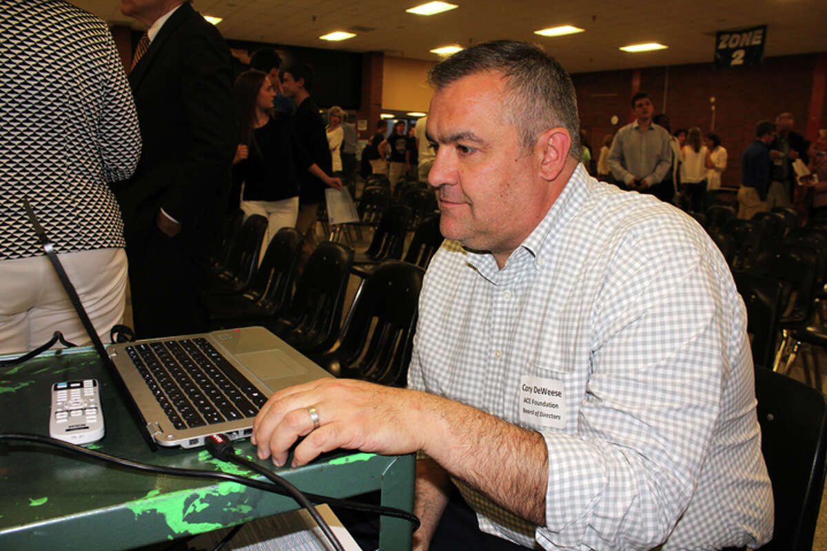 Cory DeWeese, member of the Board of Directors of ACE, finalizes the club and organization name lists on PowerPoint just before the start of the program. Names of the members of each organization were projected on the screen as student representatives and their advisers told about the activities and accomplishments of the group during 2015-2016 — Sue Berescik photo