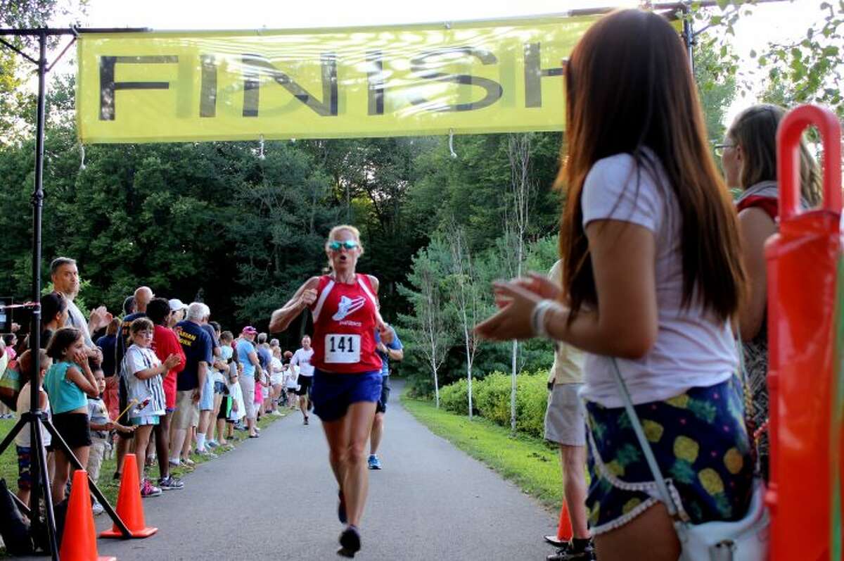 A Trumbull runner crosses the finishing line at last year's Sunset Run.