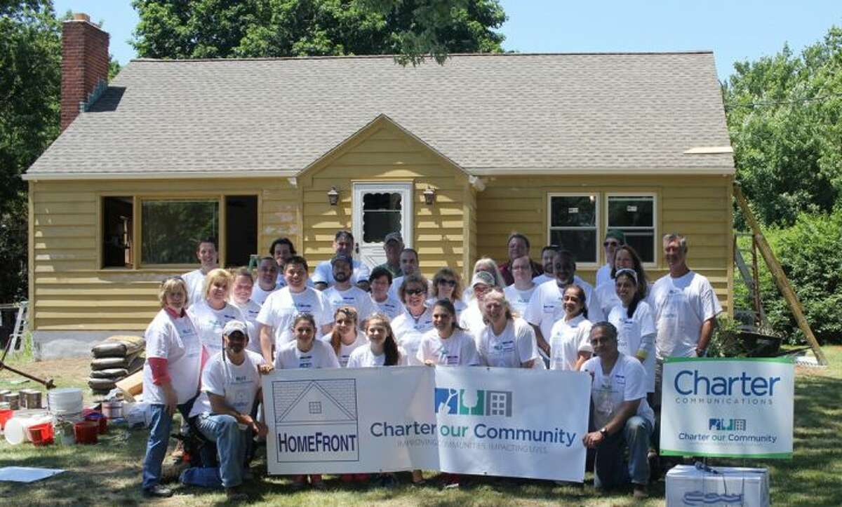 Charter Communications employees and Trumbull residents came together Saturday to make some substantial improvements to the home of Lynda Ryan.