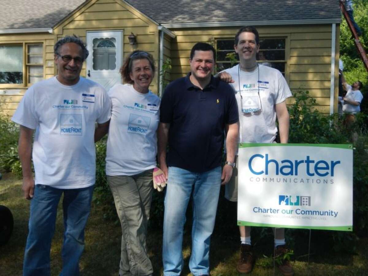 First Selectman Tim Herbst, dark shirt, stopped by Saturday to see the Charter our Community volunteers in action.