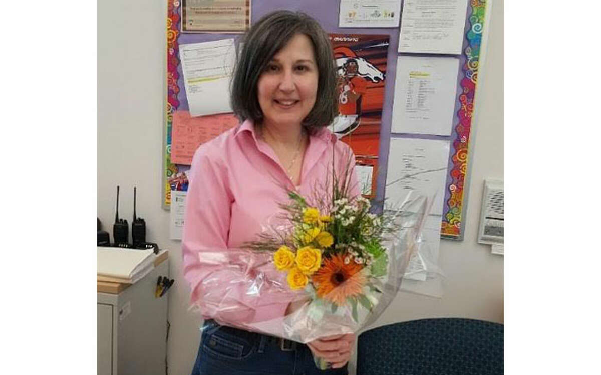 June Canale, a secretary at the Trumbull Early Childhood Education Center receiving her surprise bouquet.