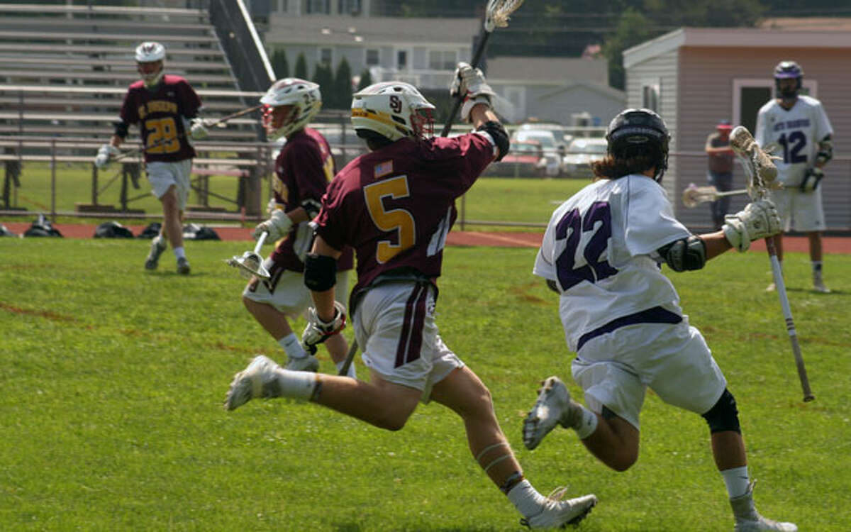 St. Joseph's Brian Harner runs down North Branford's Nico Sommo in the Cadets' 17-5 Class S boys lacrosse quarterfinal victory. — Mike Suppe photo