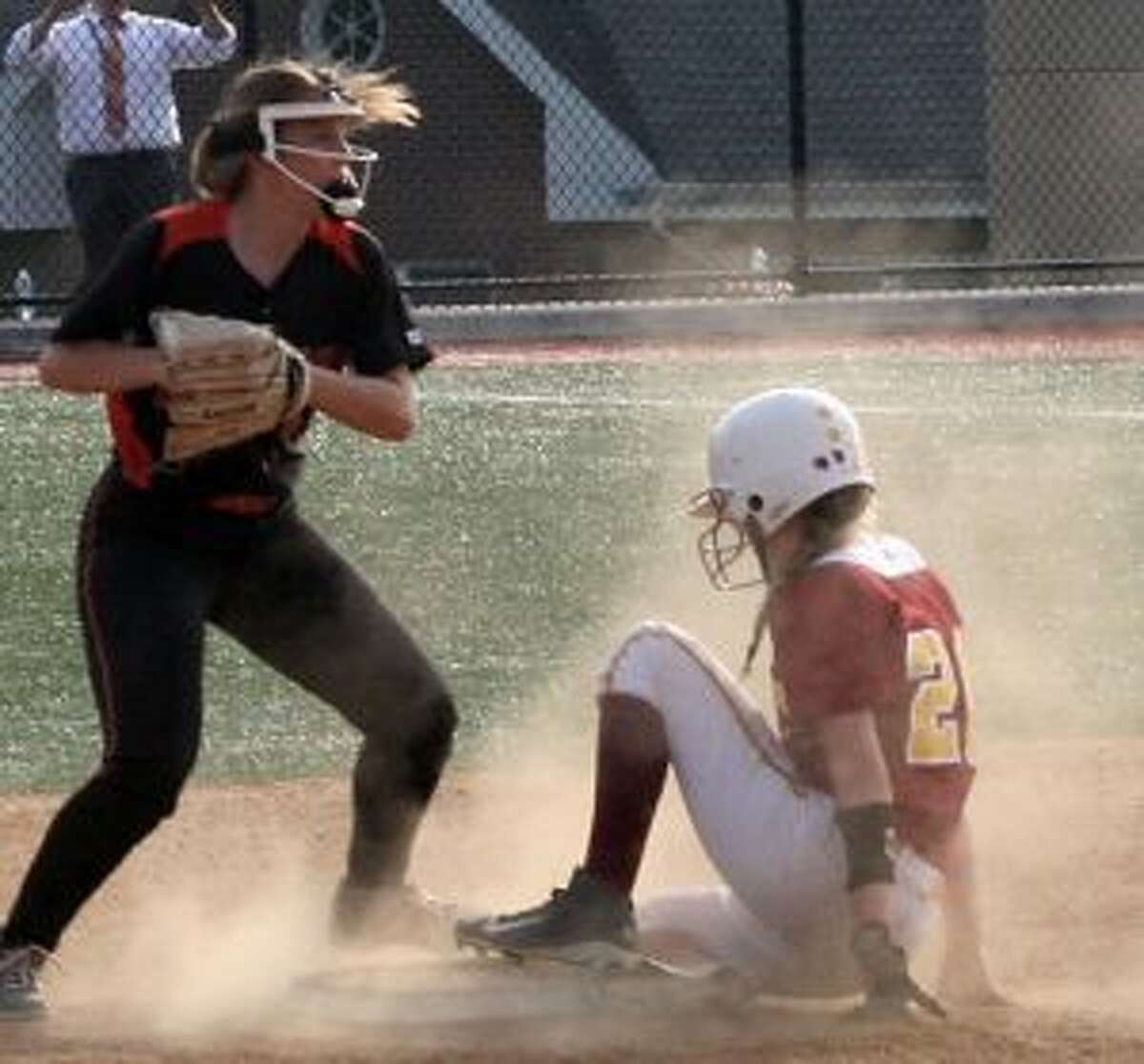 Stamford's Dana Serrichio looks to make a different play, after St. Joseph's Elena Ball slid safely into the bag.