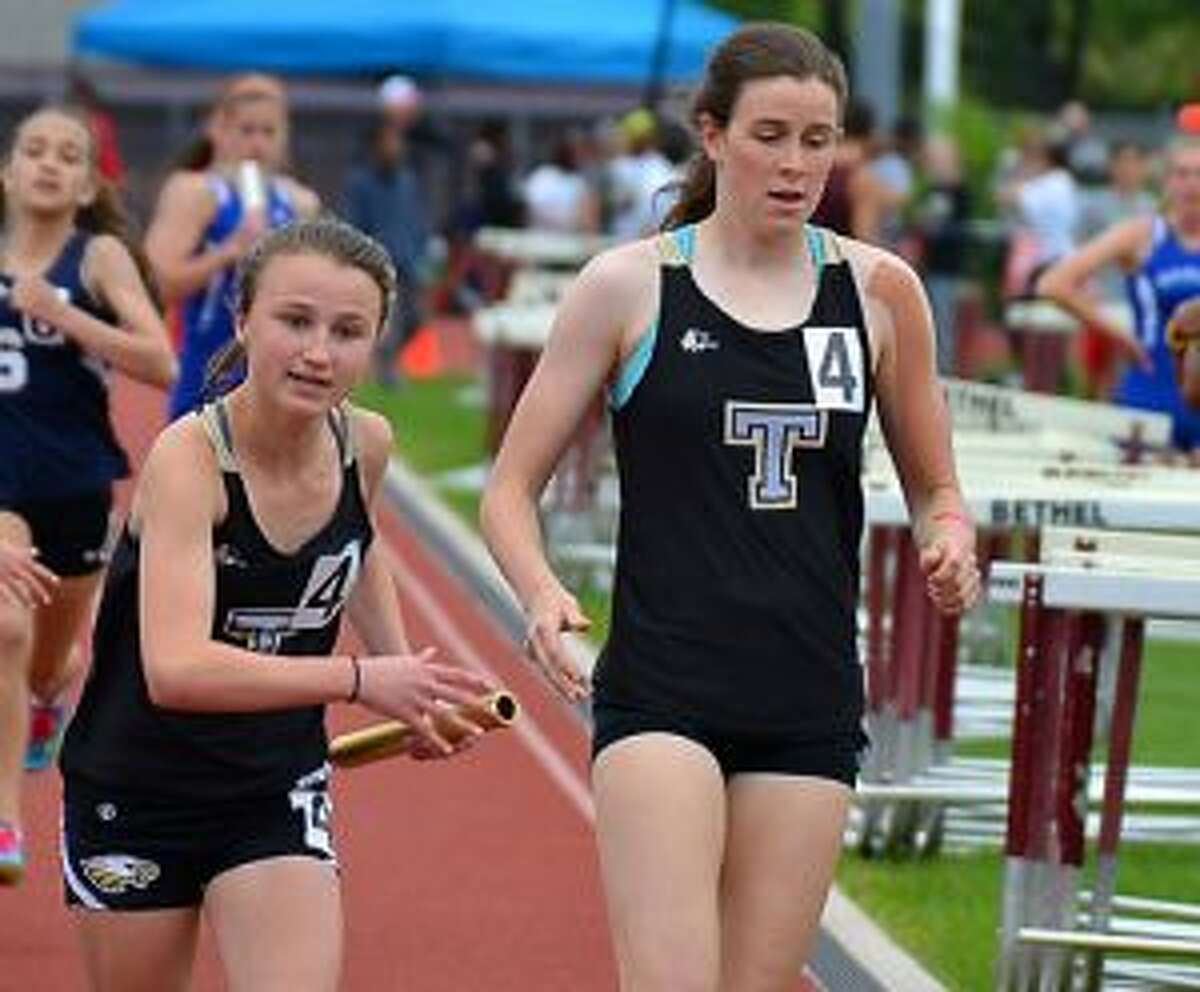 Trumbull High’s Margaret LoSchiavo takes baton from Sydney Adams in the 4x800 relay at the FCIACs. The Eagles medaled in the event with a sixth-place finish. — Lisa Romanchick photo