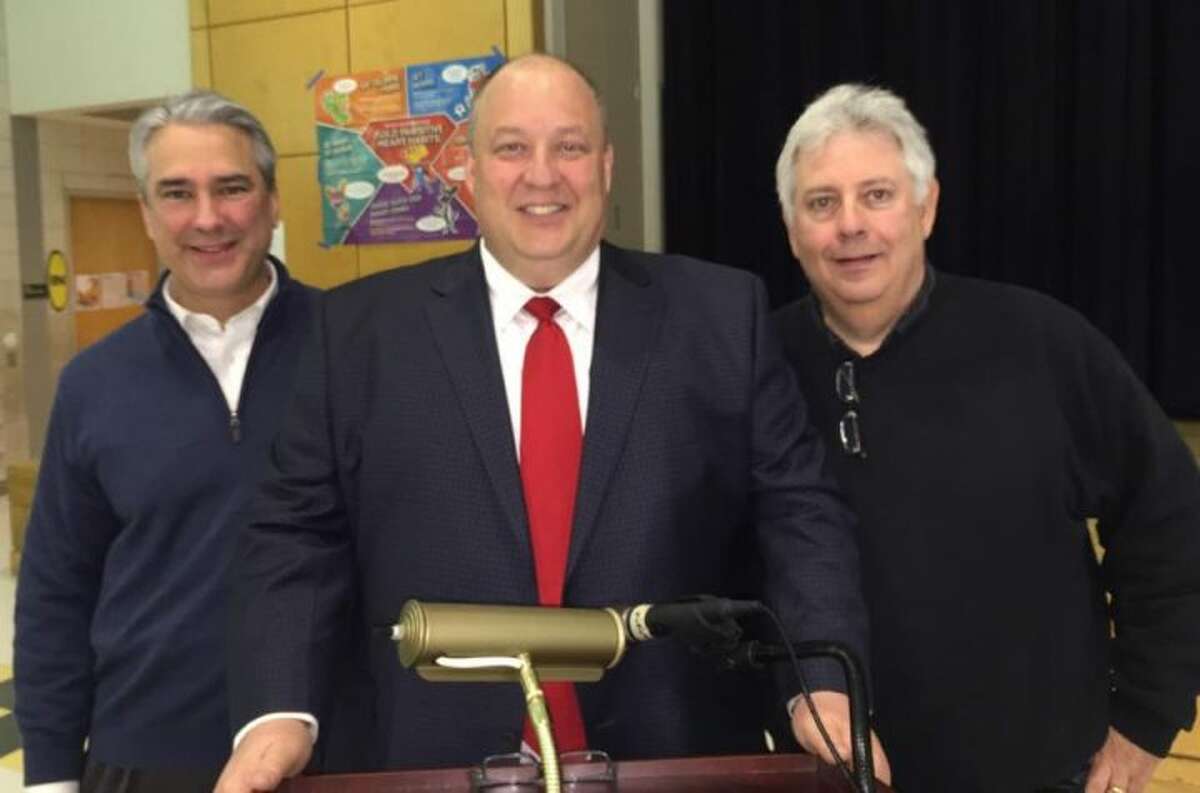 Trumbull resident Fred Garrity, middle, stands with Town Treasurer Anthony Musto and Trumbull Democratic Town Committee chairman Tom Kelly last week.