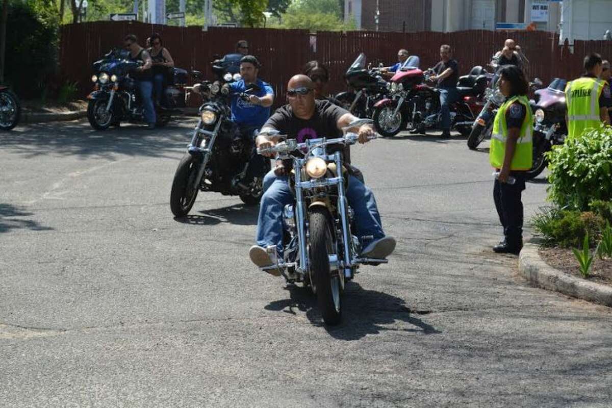 A motorcycle rider drives through downtown Bridgeport part of last year's Ride Against Child Abuse that rolls through Trumbull and benefits The Center for Family Justice.