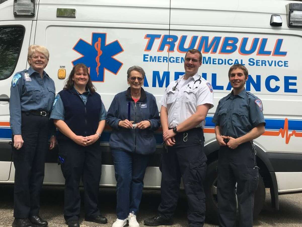 EMS executive administrative assistant Barbara Crandall, left, stands with staff members Jen DiJoseph, Chris Caulkins, and James Koch and EMT volunteer Di Watson, middle, outside the Trumbull Emergency Medical Services office on Middlebrooks Avenue. Watson, a 40-year member of Trumbull EMS and winner of the state’s Volunteer of the Year award in 2015, holds the 2016 Governor’s Award, which the department received at a reception in Hartford Monday, May 16. The Governor’s Award, which Trumbull previously took home in 2014, is open to EMS departments across the state and is the top prize for emergency service organizations. — Steve Coulter photo