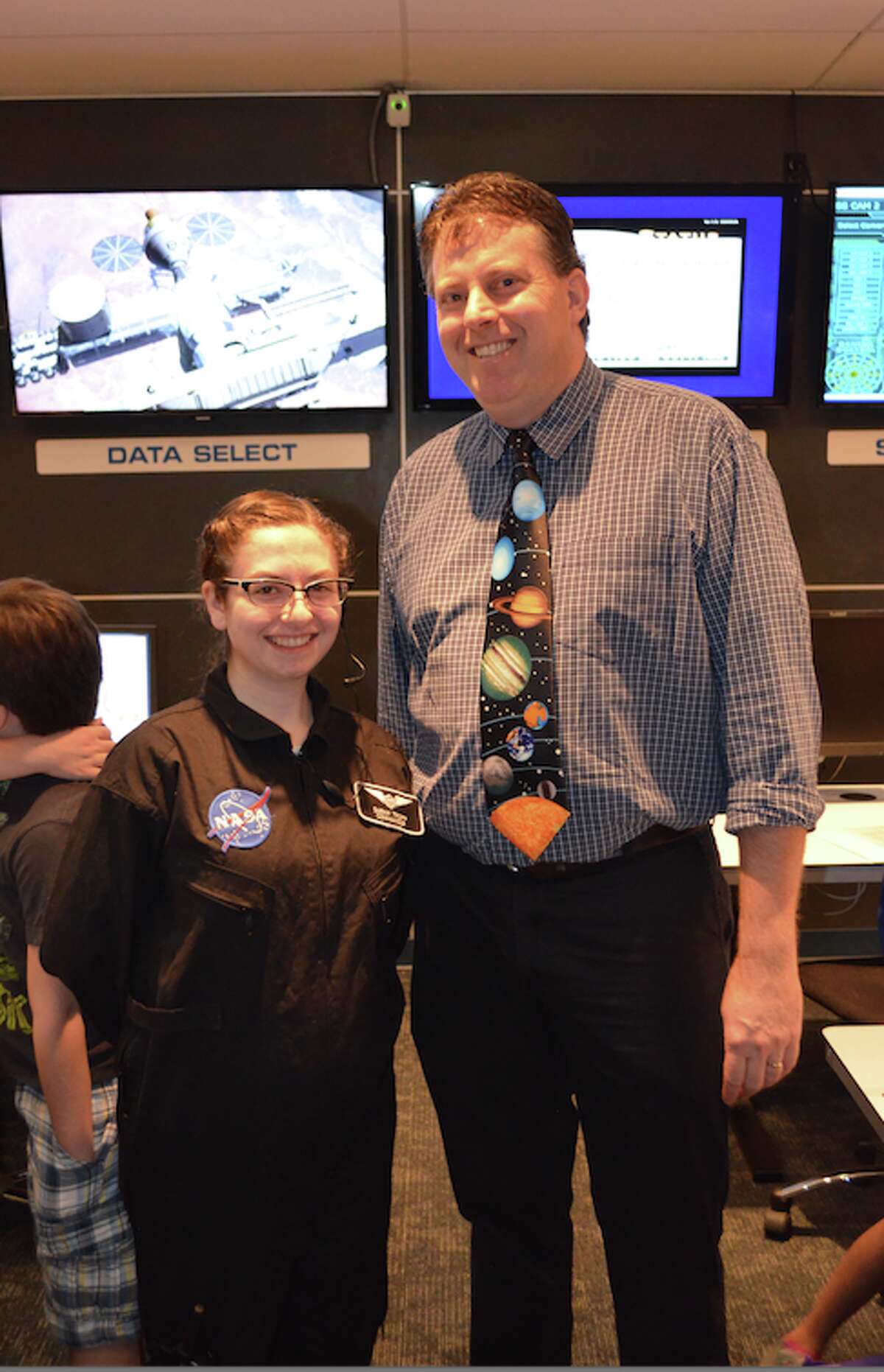 Trumbull native Sarah Tropp reunites with her fifth grade teacher, Steve Spillane, at the Challenger Learning Center in the Discovery Museum and Planetarium in Bridgeport earlier this spring.