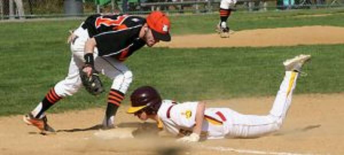 Ridgefield’s Mike O’Brien looks to get the pickoff tag down on St. Joseph’s Jake DeLeo. — Bill Bloxsom photo