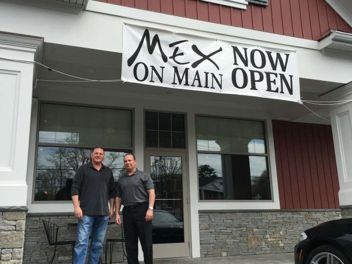 Nick Montanaro and Bill Neary, co-owners of Mex on Main, stand together under the new business’s sign. The fresh Mexican grill restaurant opened in March and has been serving customers non-stop ever since. — Steve Coulter photo