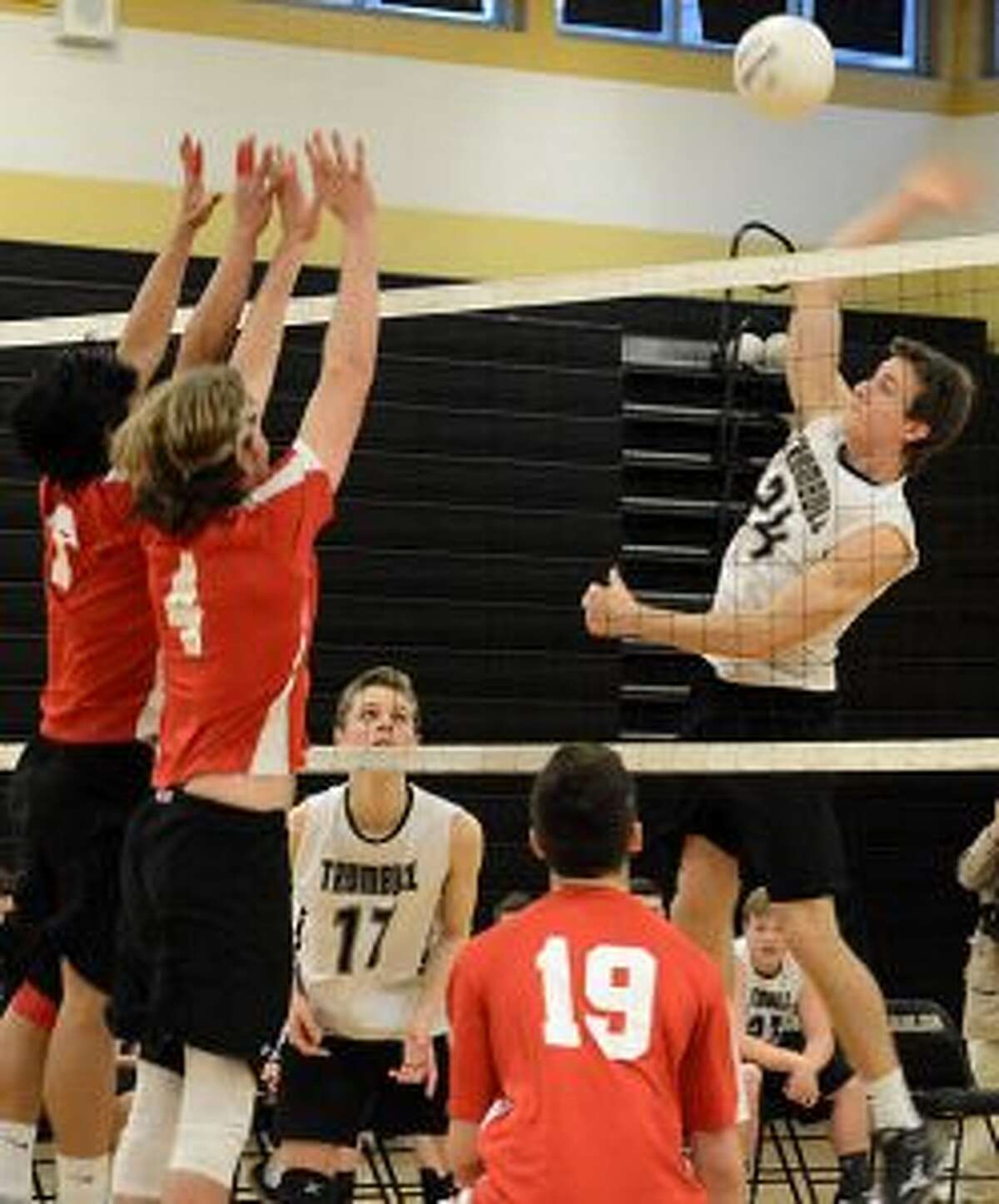 Trumbull's Casey Coughlin delivers a spike during its match with Greenwich. — Andy Hutchison photo