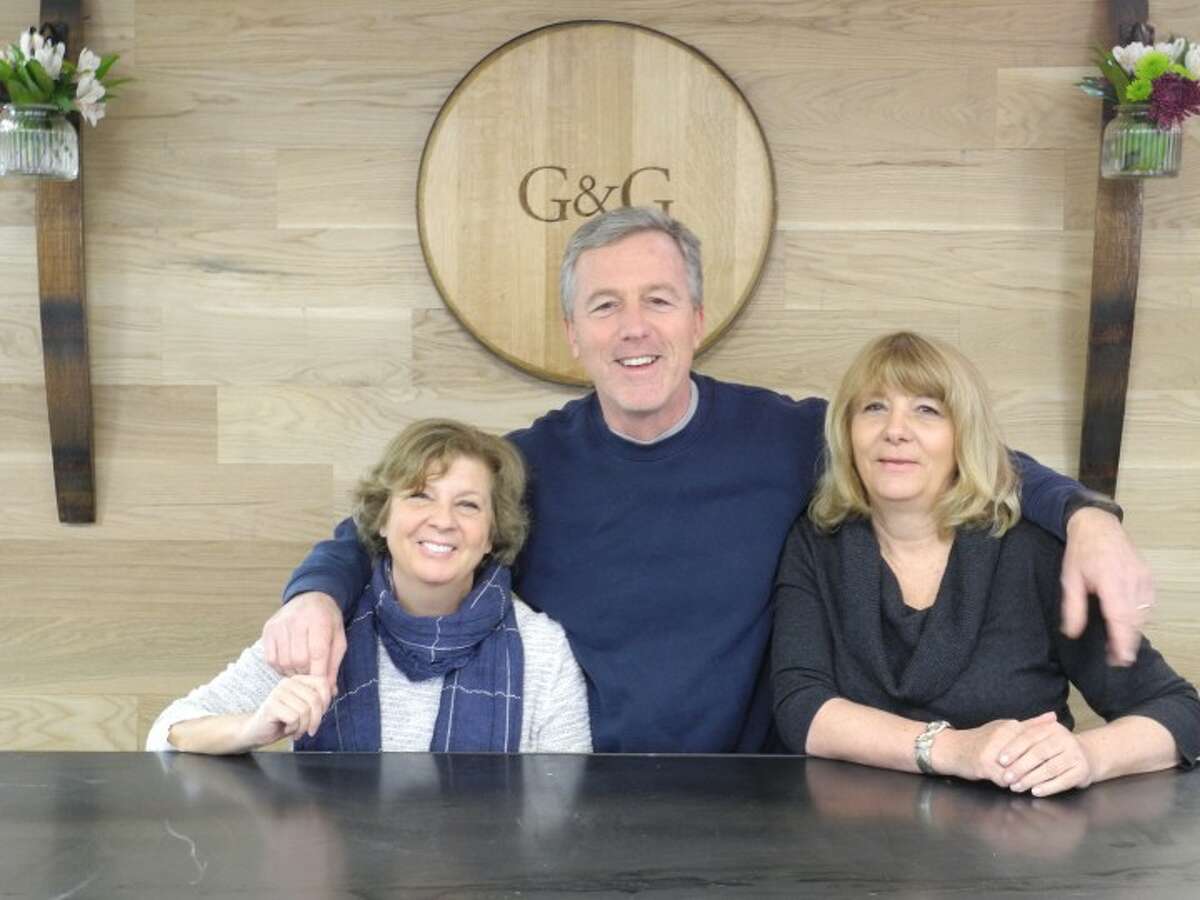 Ginna and Gene Donnelly, owners of G&G Liquors, stand behind the store's wine tasting table with manager Karen Ott. Trumbull's newest package store, located at 6528 Main Street, opened its doors on April 8 as part of the Village at Long Hill Green commercial development. - Steve Coulter photo
