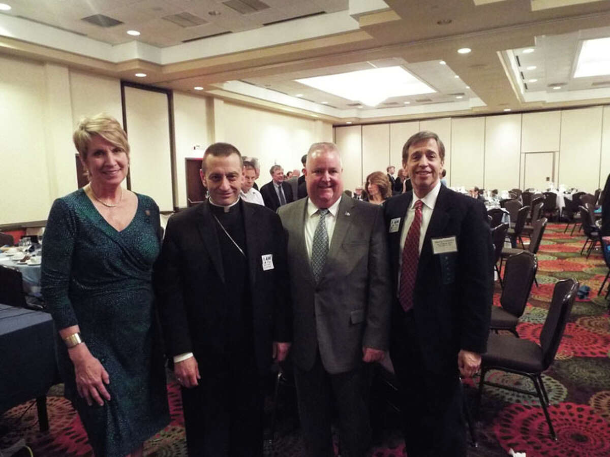 State Rep. Laura Devlin, left, stands with Bishop Frank Caggiano and State. Rep Ben McGorty at the Kennedy Center’s 65th anniversary dinner on April 7. Kennedy Center CEO Marty Schwartz, right, told The Times that the organization “started by collecting money door to door in a cigar box has now developed into an organization serving 2,000 people a year from birth through seniors.” Caggiano served as the event’s keynote speaker. — Joe Connolly photo