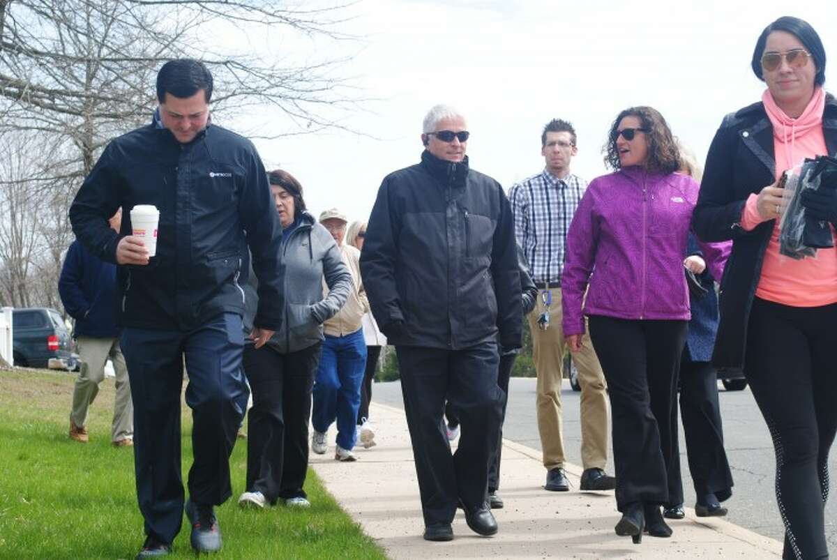 Former First Selectman Timothy Herbst leads walkers on a 30-minute health walk on April 6, 2016. This year's walk in celebration of Move More Month is Wednesday, April 10. — Joe Connolly
