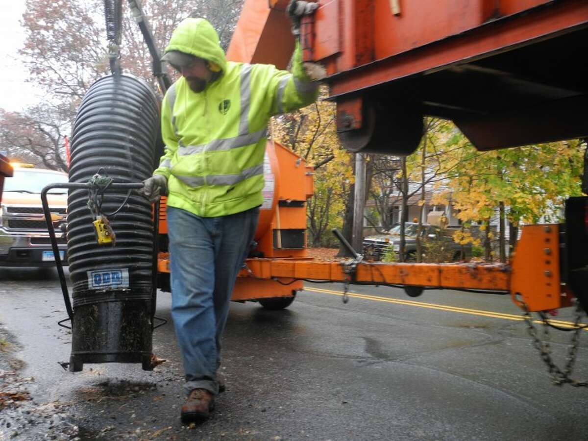 Public works employee Jim Carney operates a leaf vacuum machine during the highway department's leaf pickup program. — Steve Coulter photo