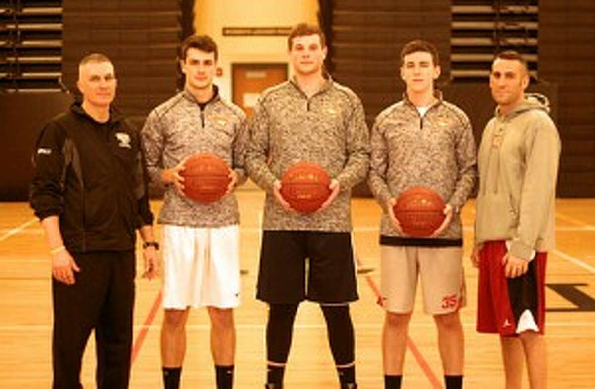 Trumbull head boys basketball coach Buddy Bray, Johnny McElroy, Ben McCullough, Jack Moore and assistant coach Matt Landin were key to the Eagles posting a 19-5 record.