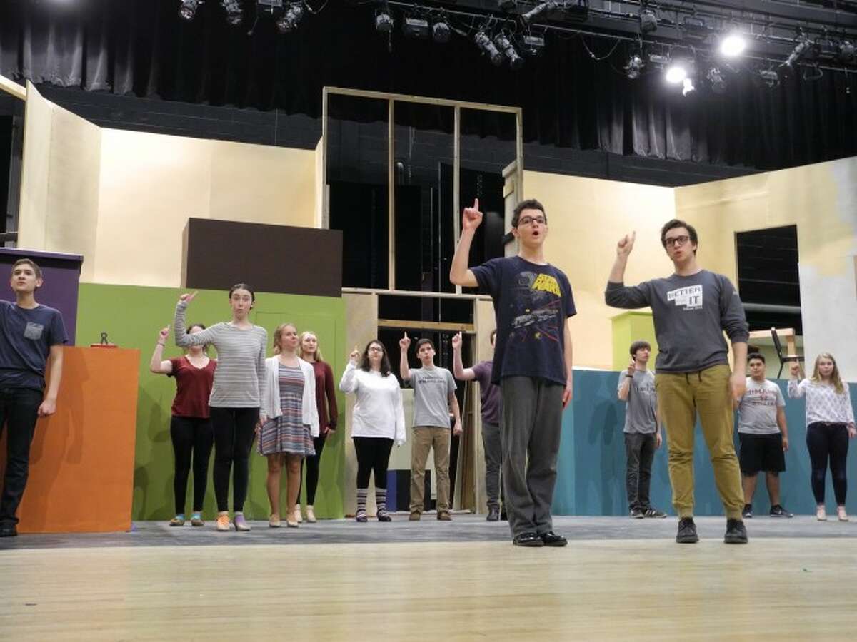 The cast of How to Succeed in Business Without Really Trying goes through a rehearsal at the Trumbull High School auditorium.