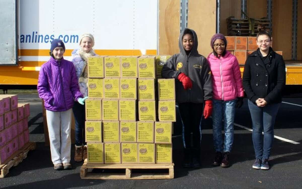 Trumbull Girl Scouts Caitlin, Catherine, Akilah, Megan, and Cassondra from Trumbull help out at the Trumbull Cookie Delivery site. Nearly two million boxes of Girl Scout Cookies arrived in Connecticut on Saturday, Feb. 27.
