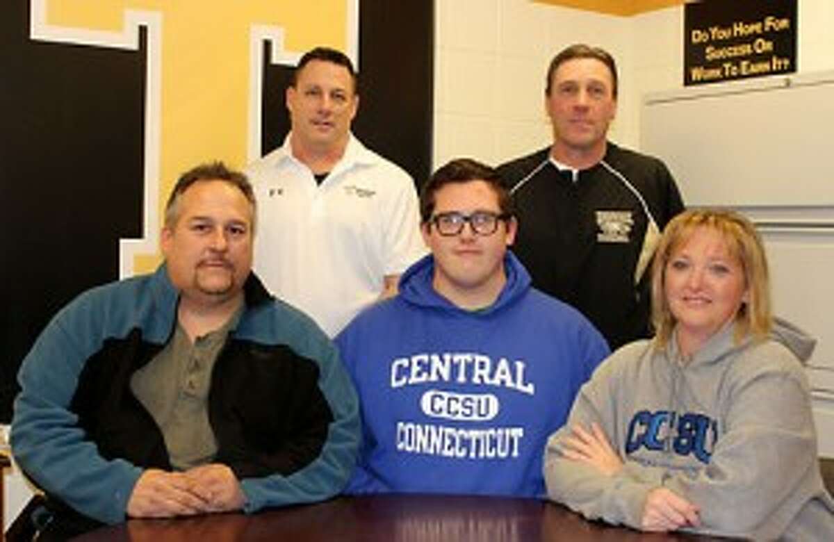 Justin Appleby, a two-way lineman at Trumbull High, has signed his letter of intent to play football at Central Connecticut State University. Appleby, flanked by his mom Darcy and dad Russell, was joined by Trumbull line coach Bill Pinto and head coach Bob Maffei. — John Kovach photo