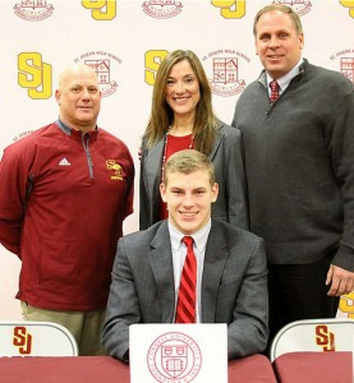 Cam Ryan has chosen to attend Cornell University. Pictured with the St. Joseph High football player are Cadets head coach Joe Della Vecchia, mom Elaine and dad Mike.