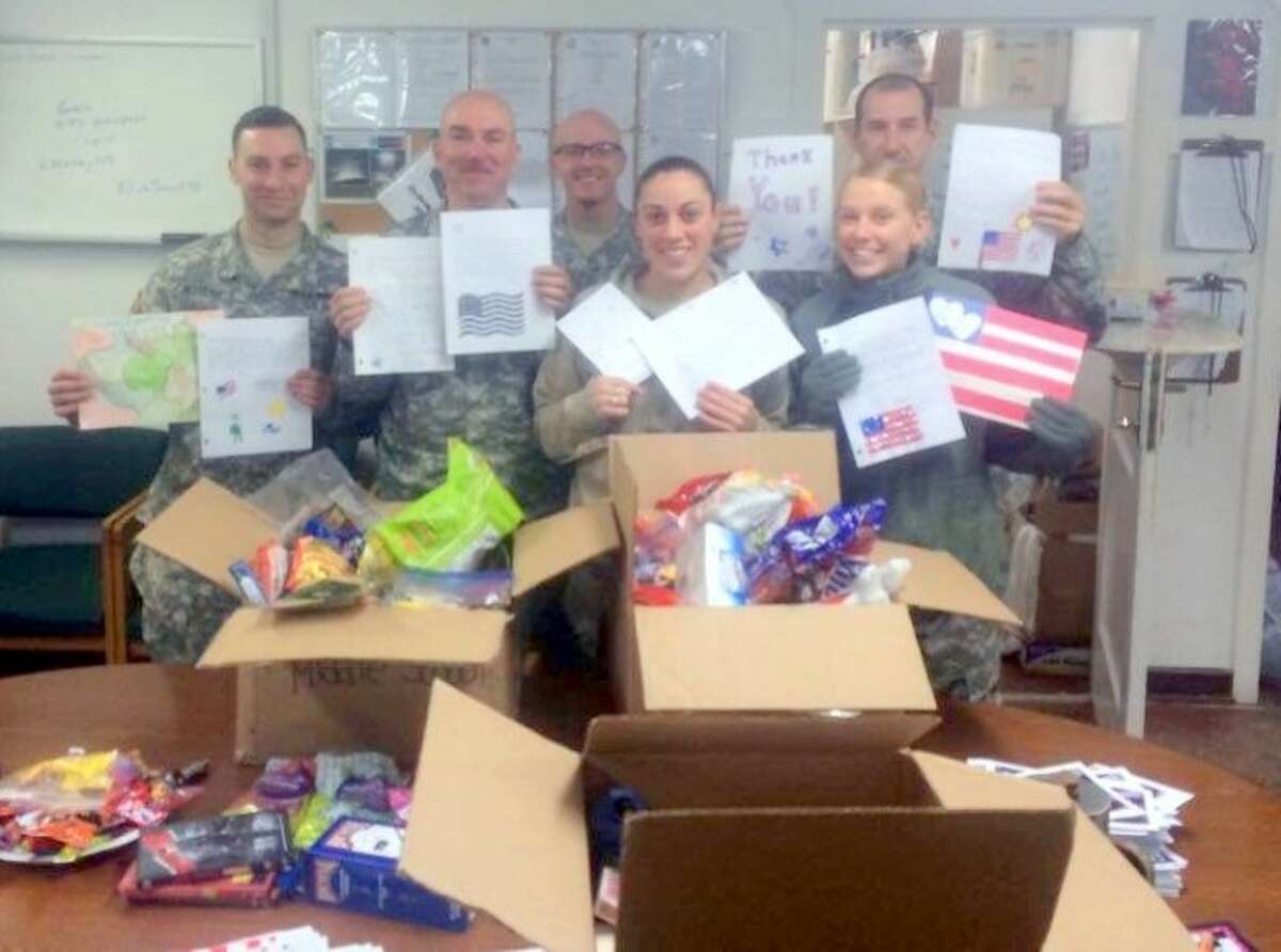 Members of Task Force Hurricane on the ground in Kosovo celebrate the arrival of their care packages from Trumbull.