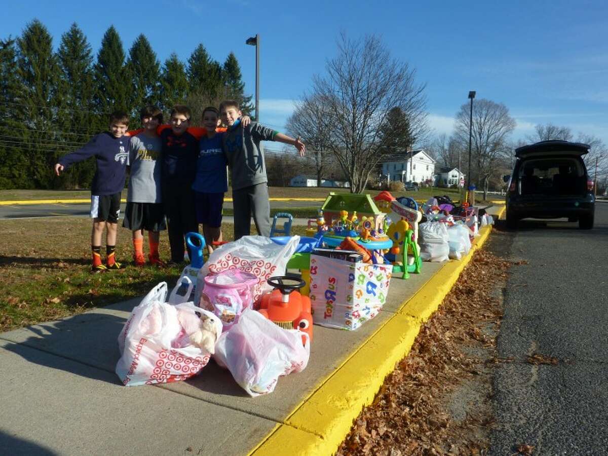 Local students collect toys outside of Tashua Elementary School part of a Second Chance Toys drive held in December.