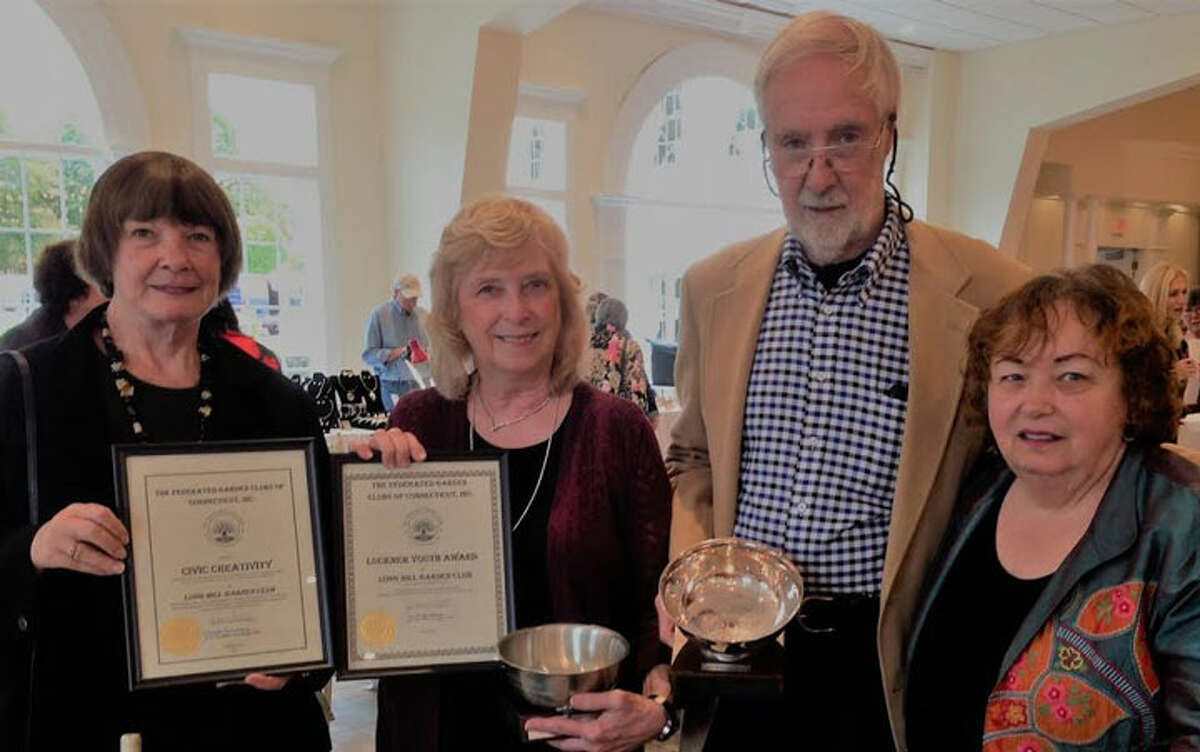 Displaying the awards given to the Long Hill Garden Club are Marilyn Burkhart, Kathy Feller, Walter Callagy and Cheryl Damiani.