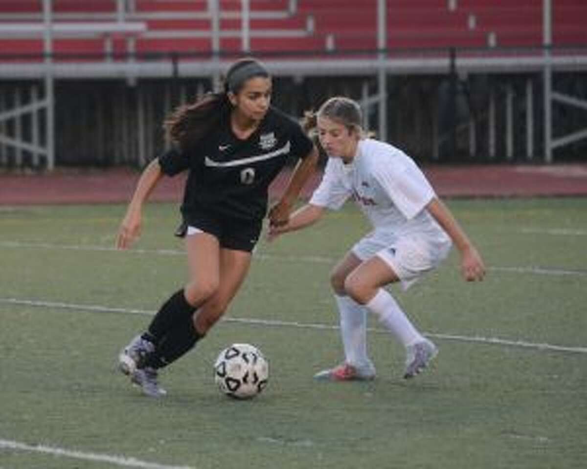 Trumbull's Skylar Jorge looks to get past a Warde defender. — Andy Hutchison photo