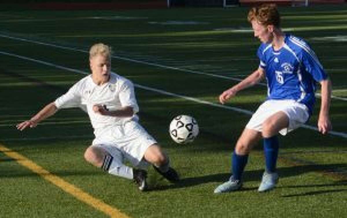 Trumbull's Connor Bluestein (21) and Ludlowe's Kieran Kilbride (15) look for possession. — Andy Hutchison photo