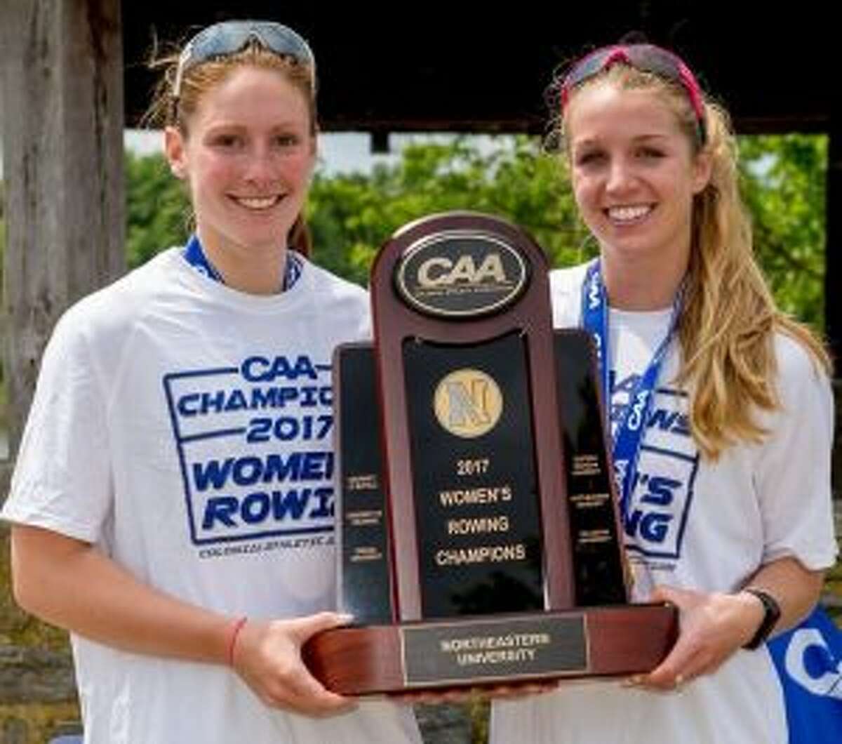Maggie Walsh (left) and fellow co-captain Heather Foti accept Northeastern's first place trophy at the May 2017 Colonial Athletic Association Championships. It was the fourth straight CAA Championship for coach Joe Wilhelm's Huskies.