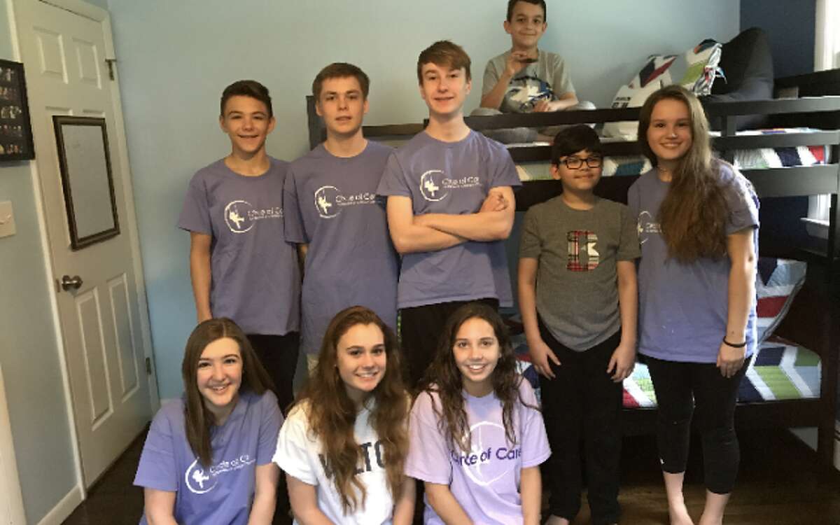 Bernardo, second from right, and his brother Sebastian, on bed, recently received a gaming-themed bedroom makeover from Wilton High School students, from left, top row: Isaac Quantock, Connor Uitterdijk, Erynn Fray and Emma Snyder; bottom row: Alex Buse, Allie Courtney and Katie Buse in their new bedroom. — Contributed photo