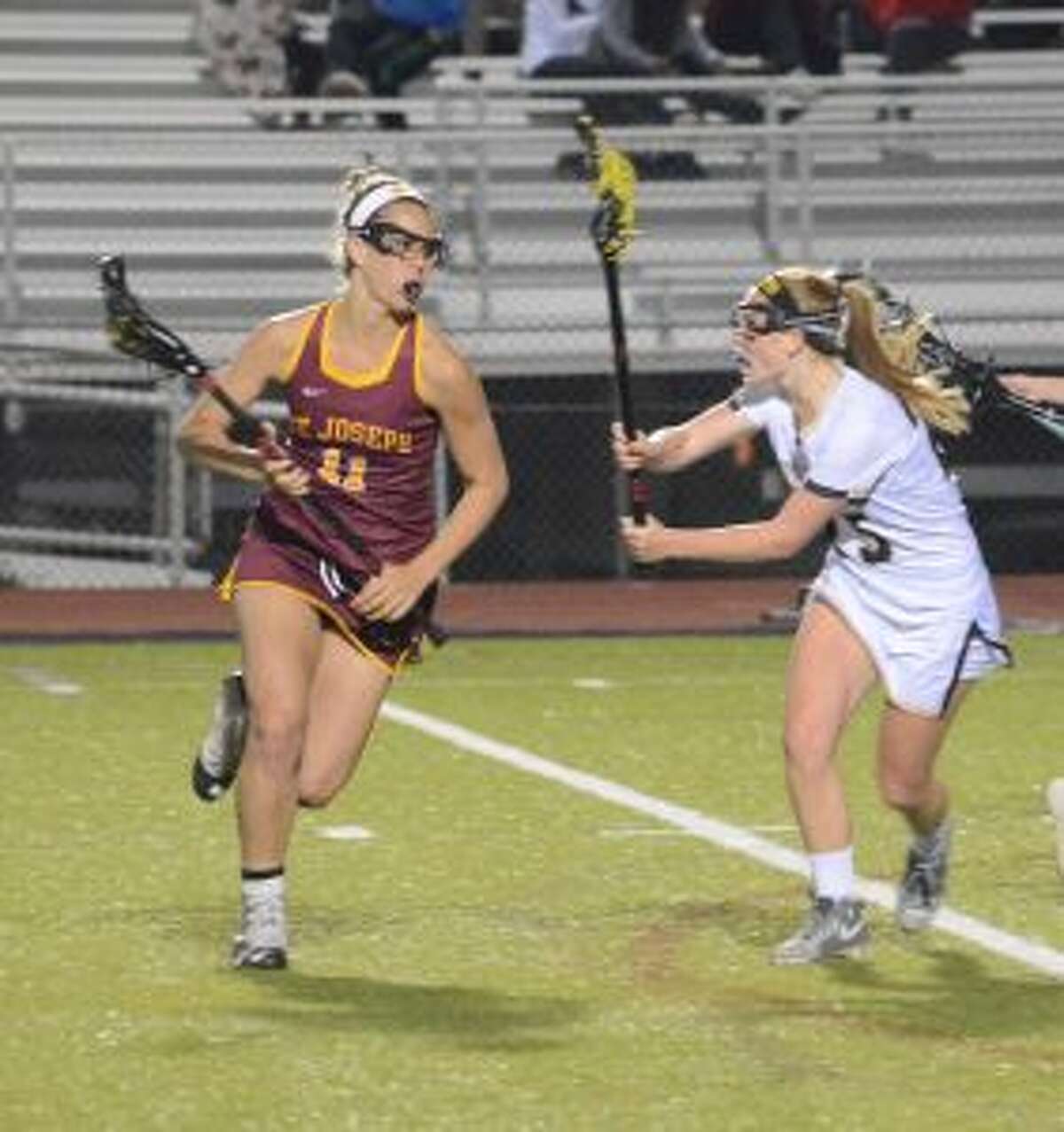 St. Joseph's Kate Condron is marked by Trumbull High's Courtney Lynch. — Andy Hutchison photo