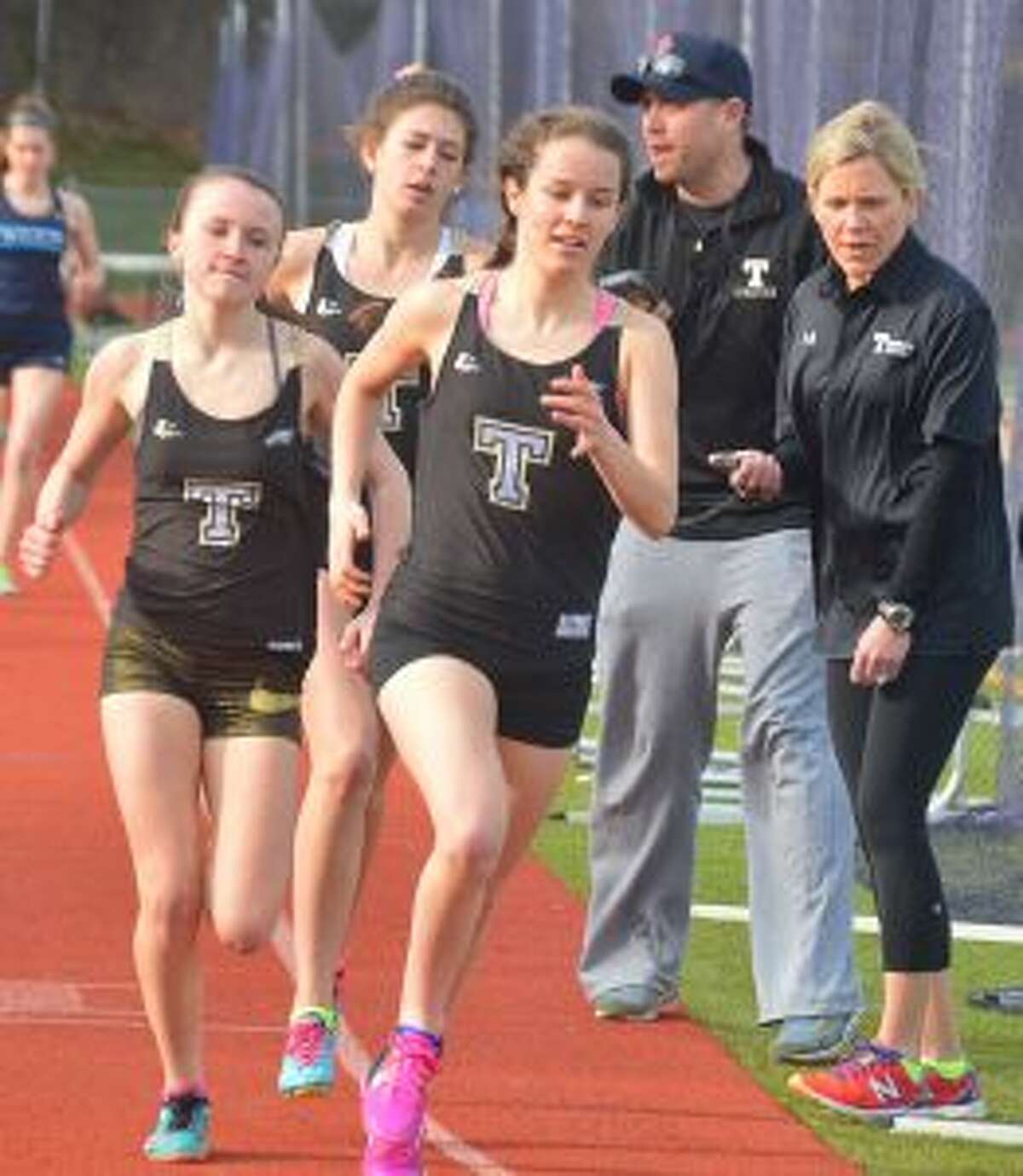 Margaret LoSchiavo won the 3200 meter run in a personal best of 12:12, Ashley Storino placed first in the 1600 meter run at 5:26 and Kate Romanchick took the win in the 800 meter run in 2:30. Looking on are coaches Jim McCaffery and Carrie Hall.