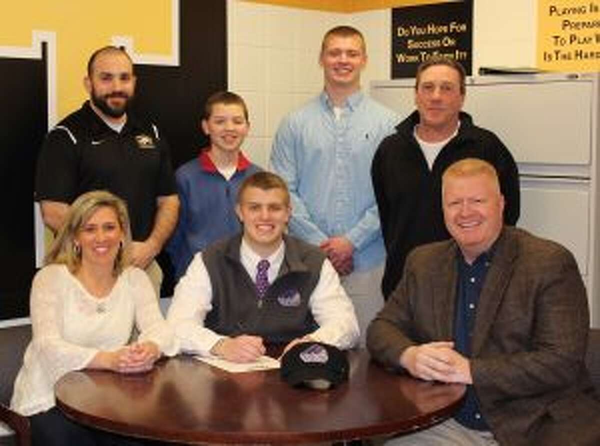 Ryan Kelly has signed to play football at Stonehill College. Pictured (front row) are Monica Kelly (mom), Ryan Kelly and John Kelly (dad); (second row) Trumbull assistant coach Gene Cellini, brothers Danny and Jack Kelly and Trumbull head coach Bob Maffei.