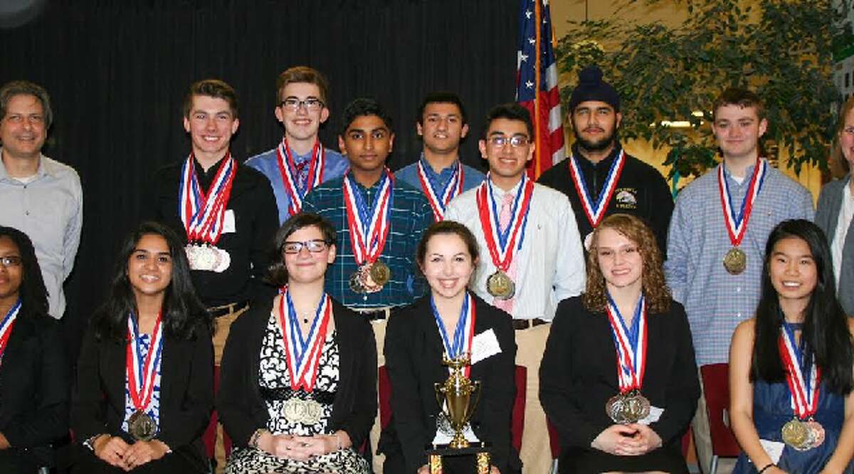 Trumbull Academic Decathlon team members with their medals from the state competition. In back, from left, co-coach Dean Pelligra, Vittorio Colicci, Connor Flaherty, Lalith Gannavaram, Viraj Dongaonkar, Ishan Negi, Harshpreet Singh, Robert Foley, and co-coach Sara Ellis. In front, Daejah Woolery, Saloni Shah, Sophie Calandro, Alexandra Dima, Elisabeth Stankevitz, and Claudia Zhang.